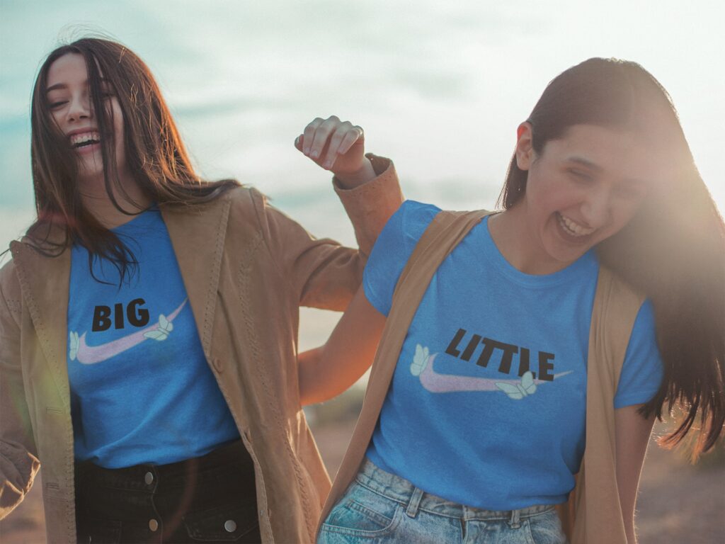 two laughing women in smae tshirt