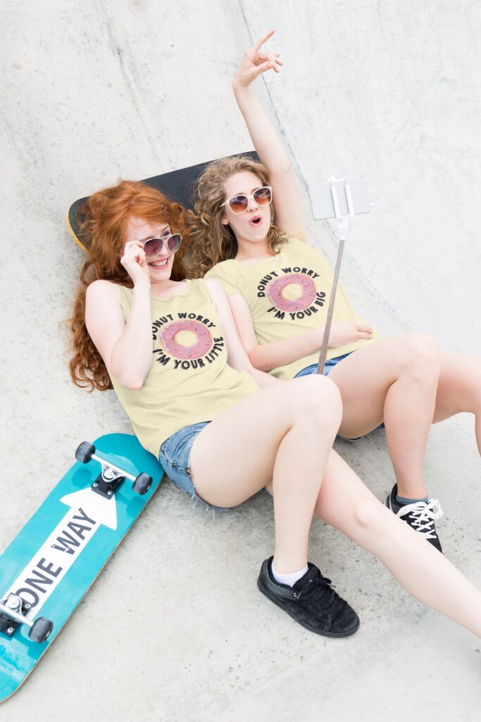 two female wearing same tshirts with skatings