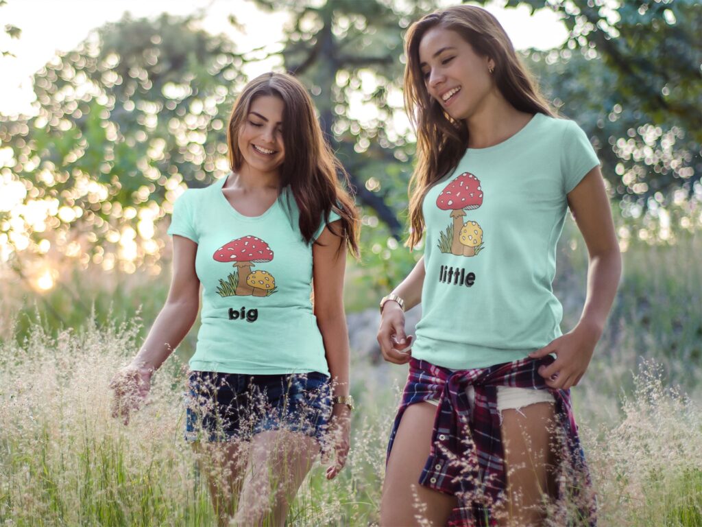 Two girls wearing different tshirts mockup having fun while walking outdoor